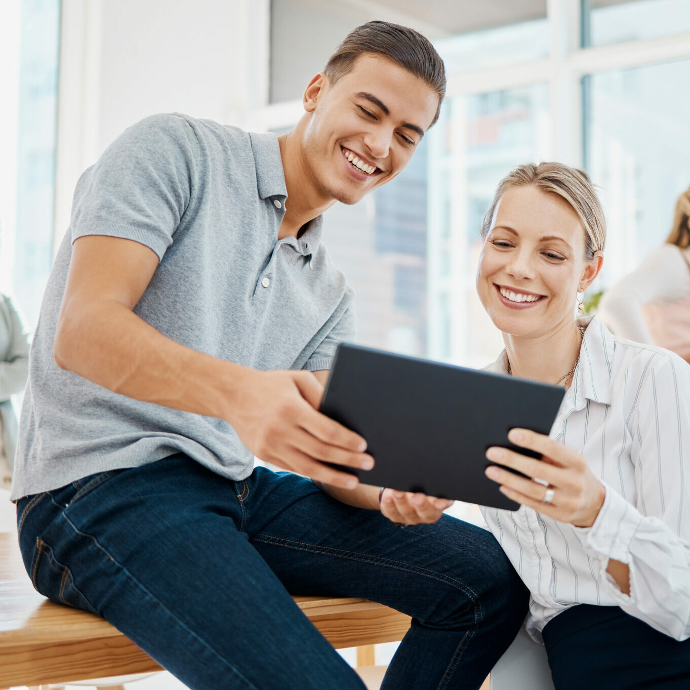 A group of staff members gather informally in a conference room.